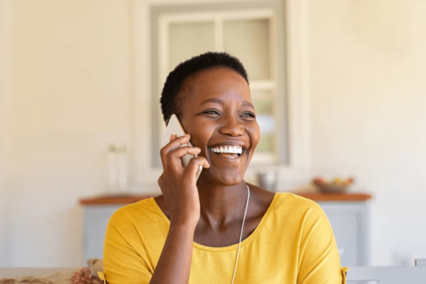 Woman smiling during a phone consultation